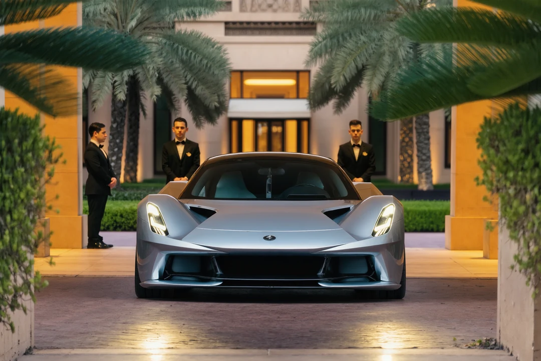 A red supercar is parked between other luxury cars on a city street, with several people standing and taking photos nearby.
